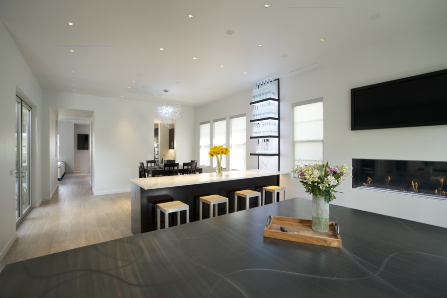 A living room and dining room featuring in-ceiling Sonance speakers.