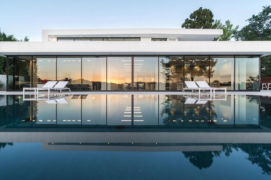 backyard pool view looking toward a luxury home.